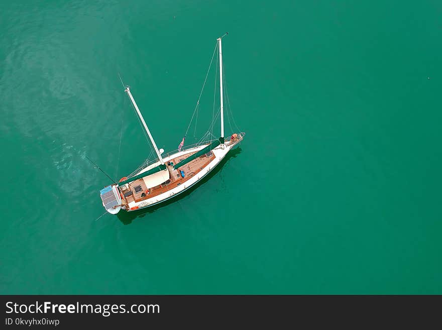 White Sailing Boat on Body of Water