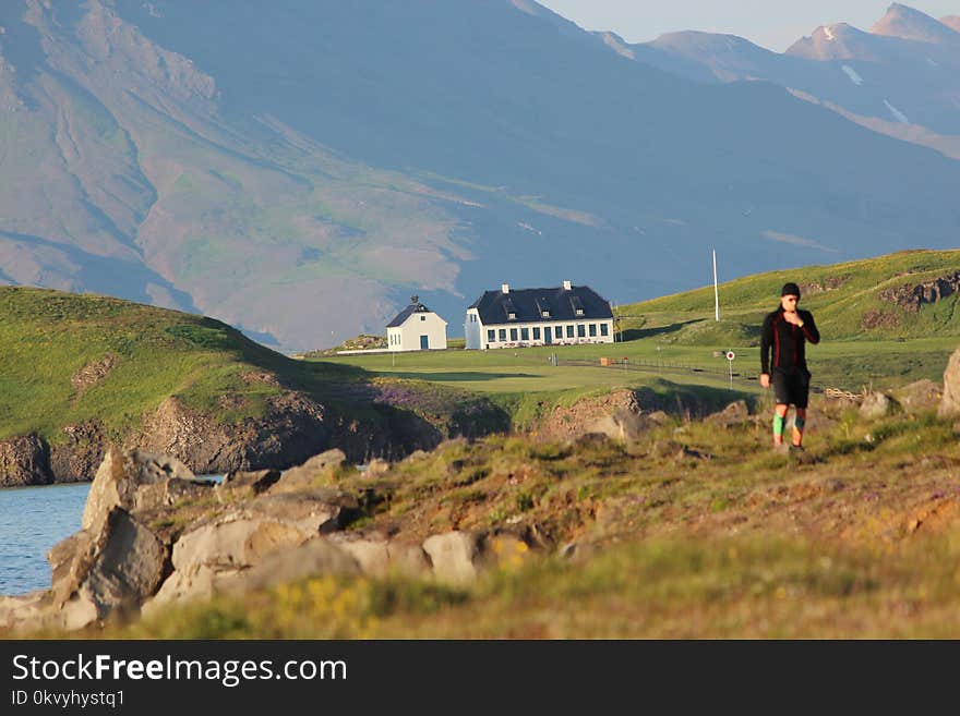 Woman Wearing Lack Outfit Walking Near Rocks