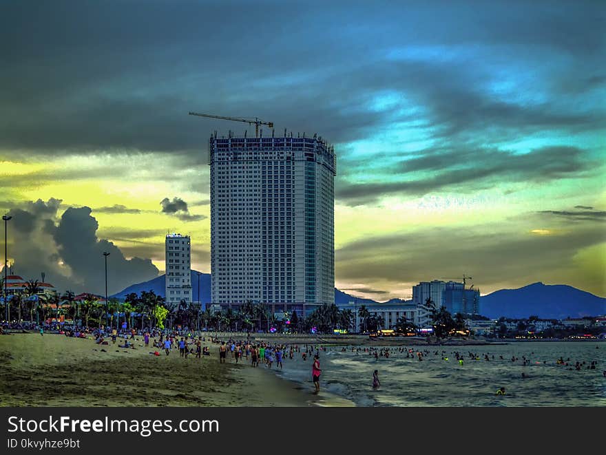 White Concrete High-rise Building Near Sea at Daytime