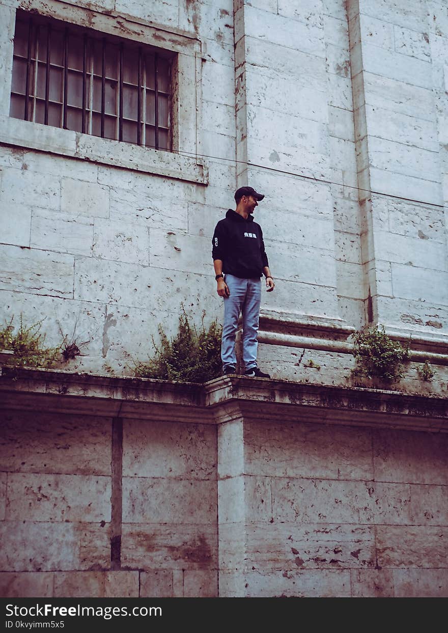 Man in Black Hooded Jacket Standing on Edge