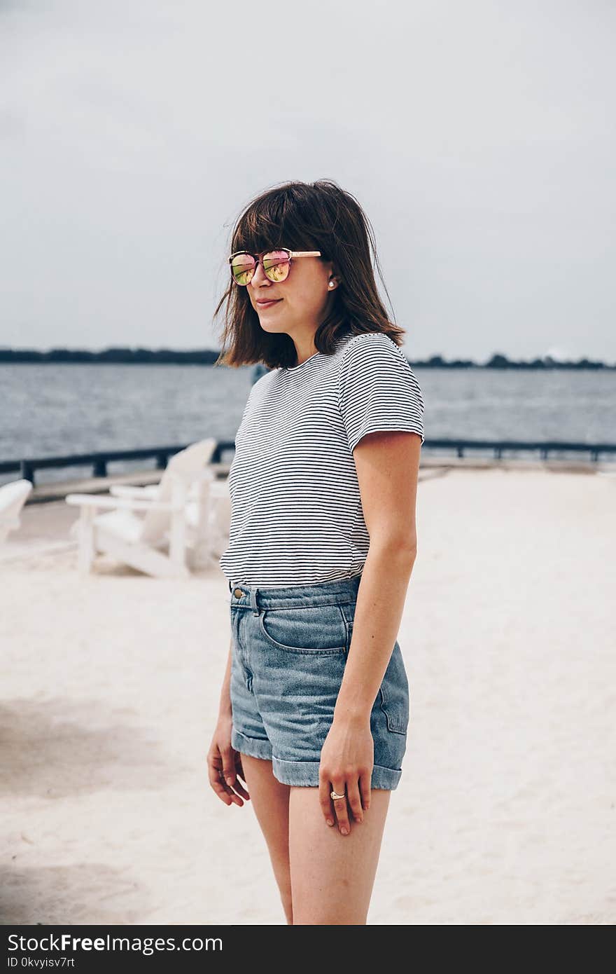 Smiling Woman Wearing Black and White Striped Shirt and Blue Short Shorts