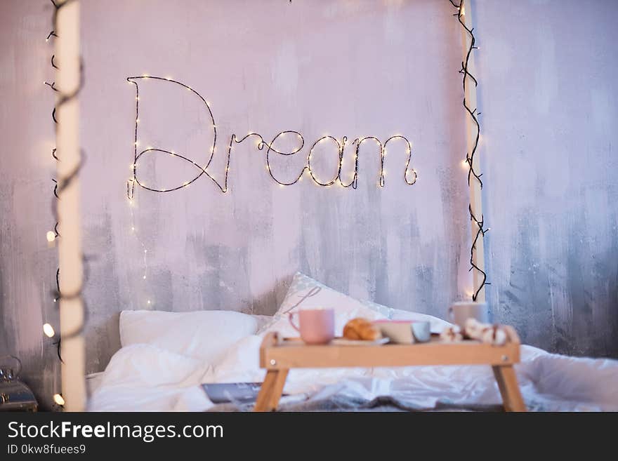 Beautiful photozone with a big bed and the word Dream