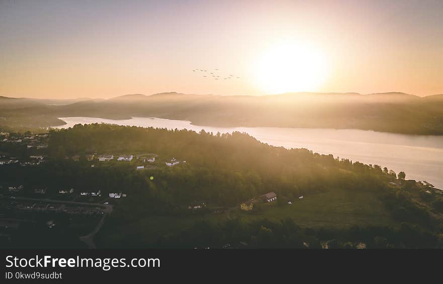 Body of Water Beside a Green Land Formation