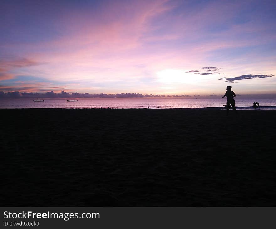 Silhouette of Person Near Sea