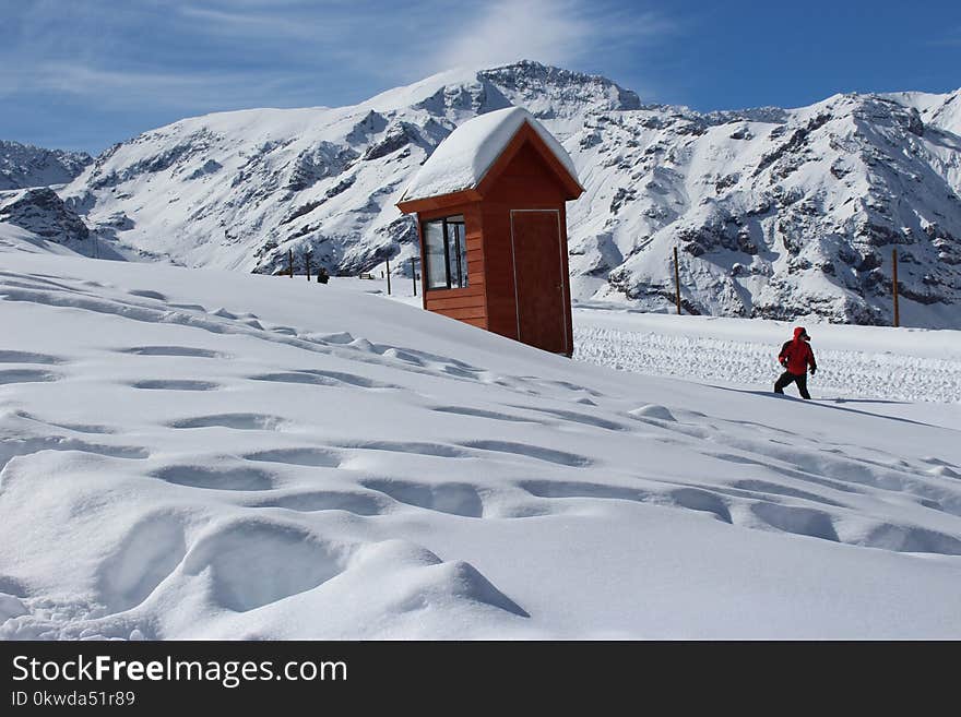 Person Doing Snow Ski Near House