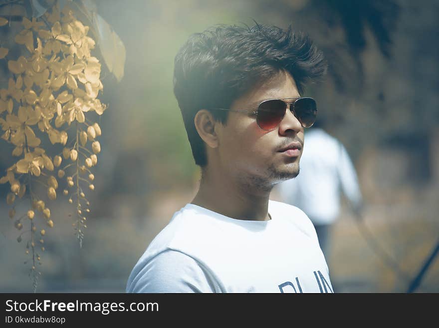 Tilt Shift Lens Photography of Man Wearing White Crew-neck Top