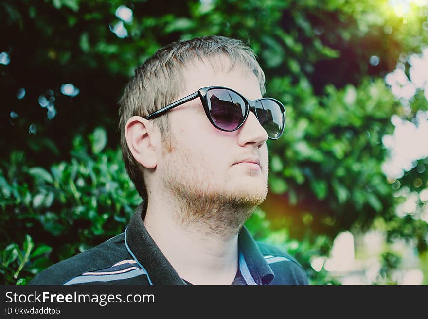 Man Wearing Black Sunglasses and Polo Shirt