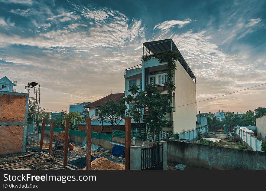 White Concrete Building Under Cumulus Clouds