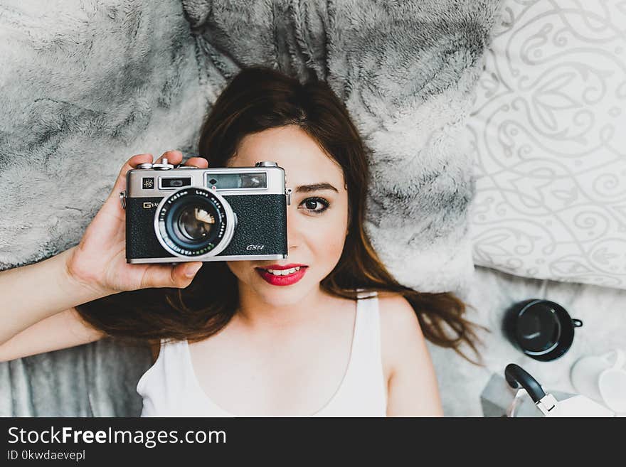 Woman Wearing White Tank Top Holding Black Camera