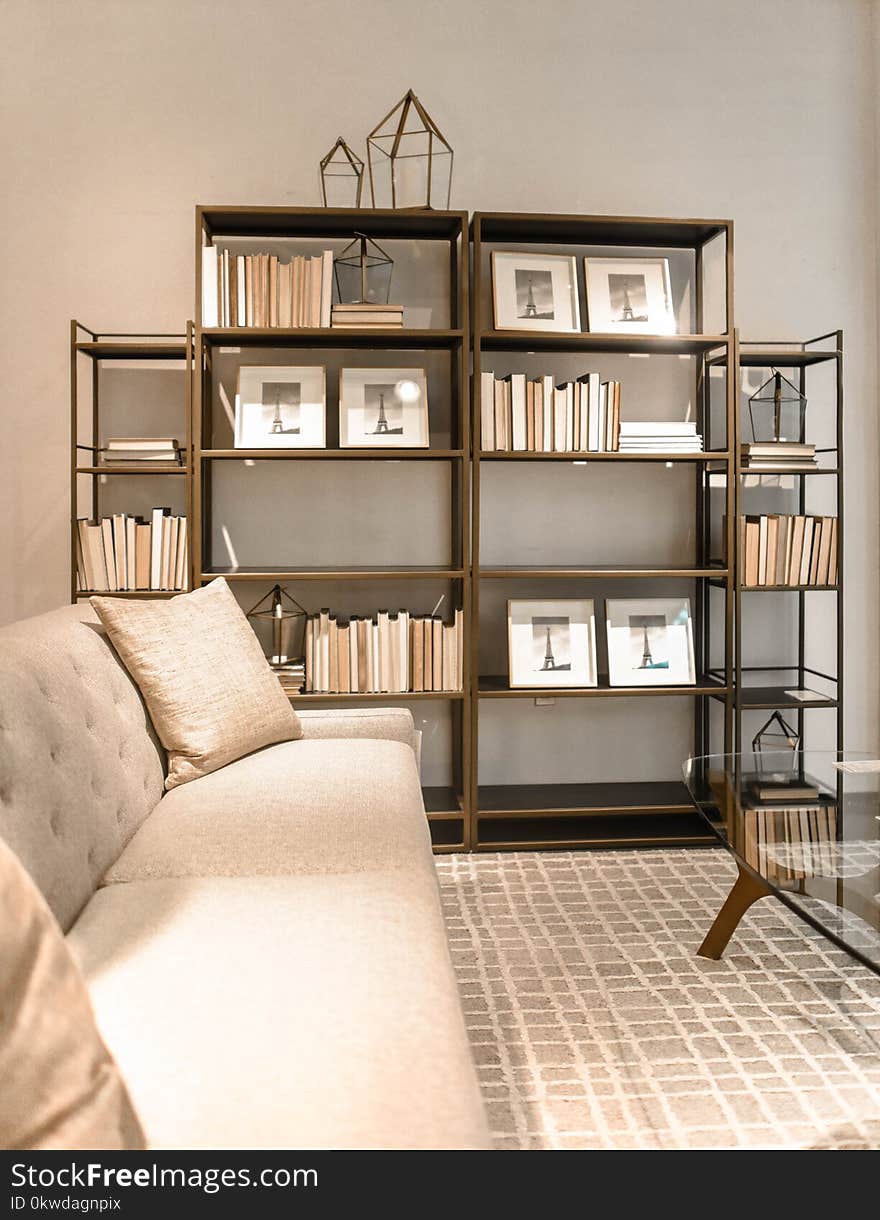 Brown Wooden Shelf and Beige Fabric Sofa