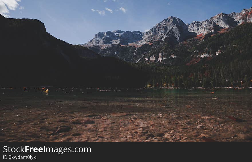 Body Of Water Beside Mountain