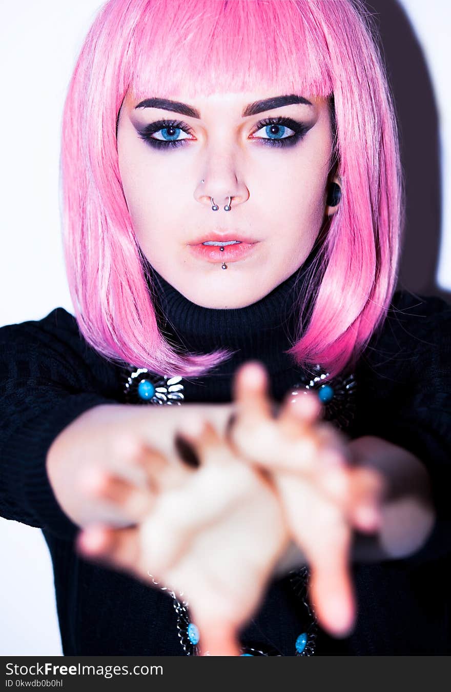 Pink Haired Woman Wearing Black Shirt With Nose And Lip Piercings