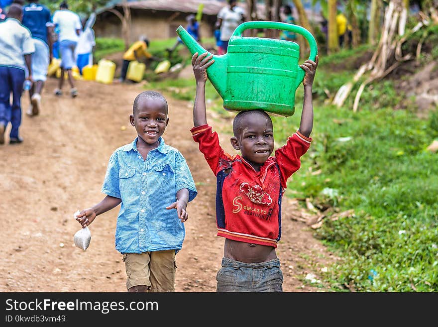 Two Boys Walking Beside the Grass