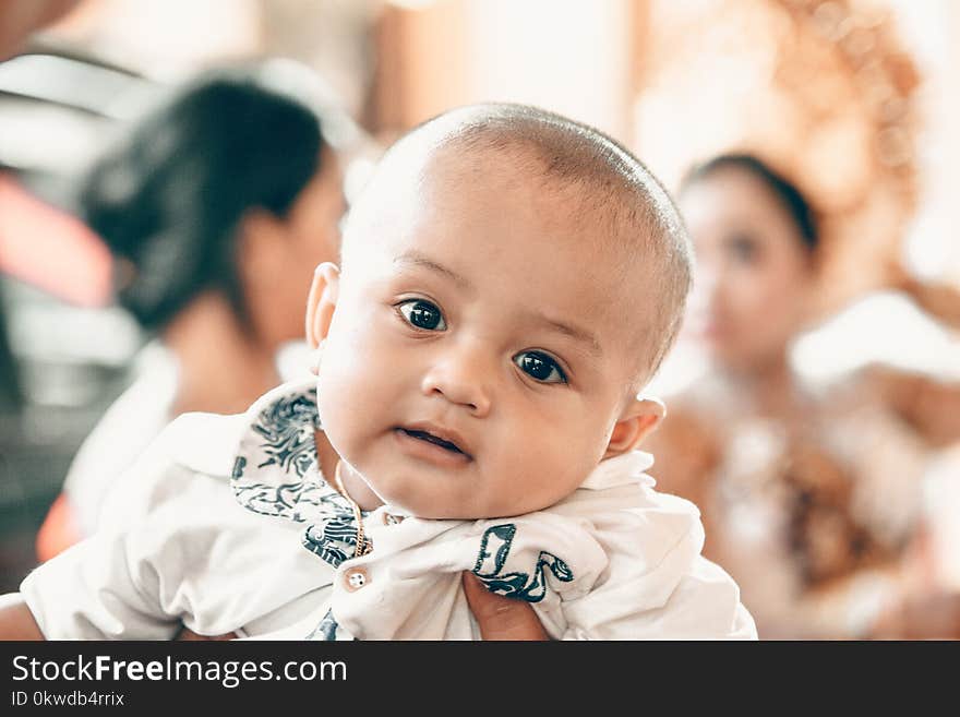 Baby in White Top in Tilt Shift Lens Shot