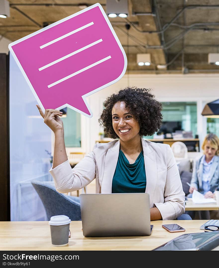 Woman Wearing Blazer Holding Pink And White Chat Bubble