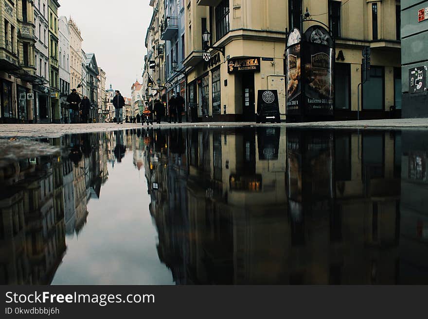 Reflection Of Buildings On Puddle