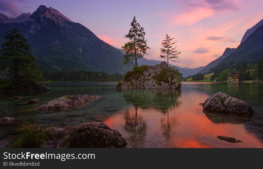 Lake Surrounded By Mountains During Golden Hour