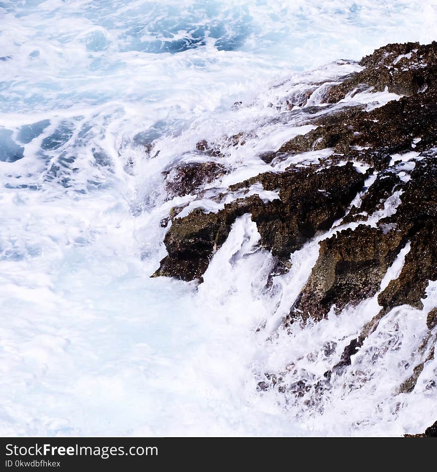 Ocean Waves Crashing on Rock Formation