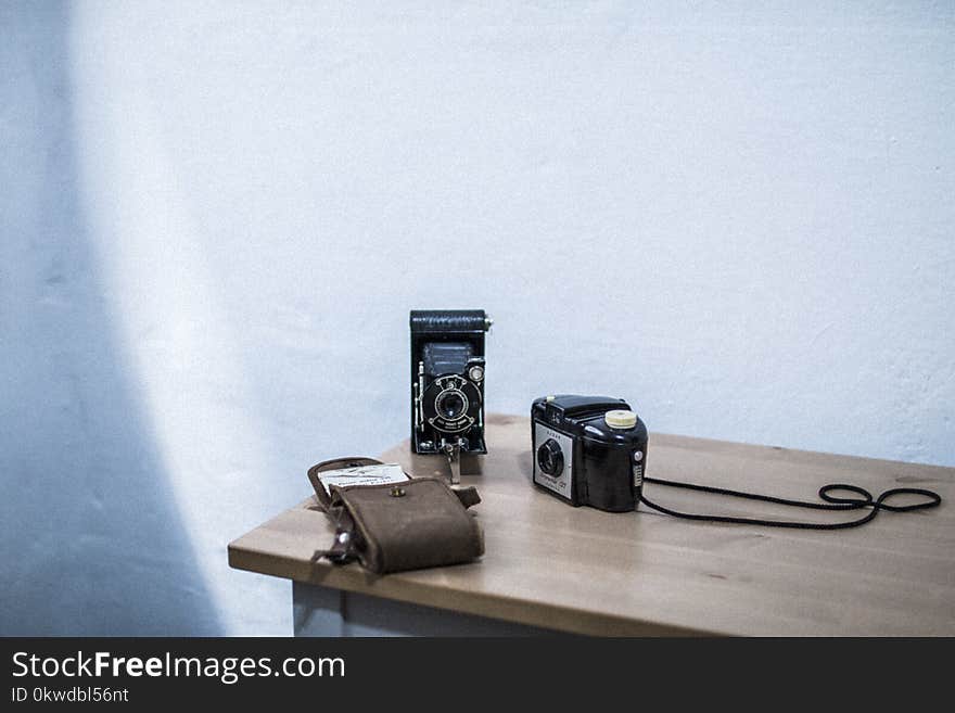 Black and Gray Folding Camera on Table