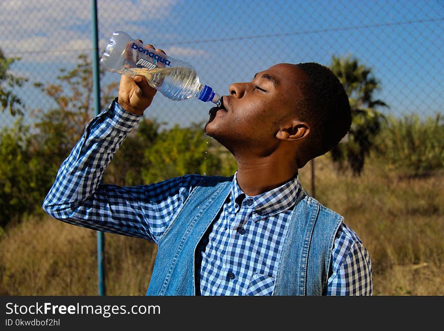 Photography of A Man Drinking Water