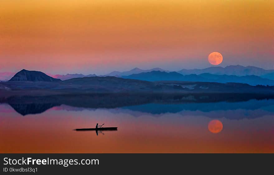 Man On the Boat Near Mountains During Golden Hour