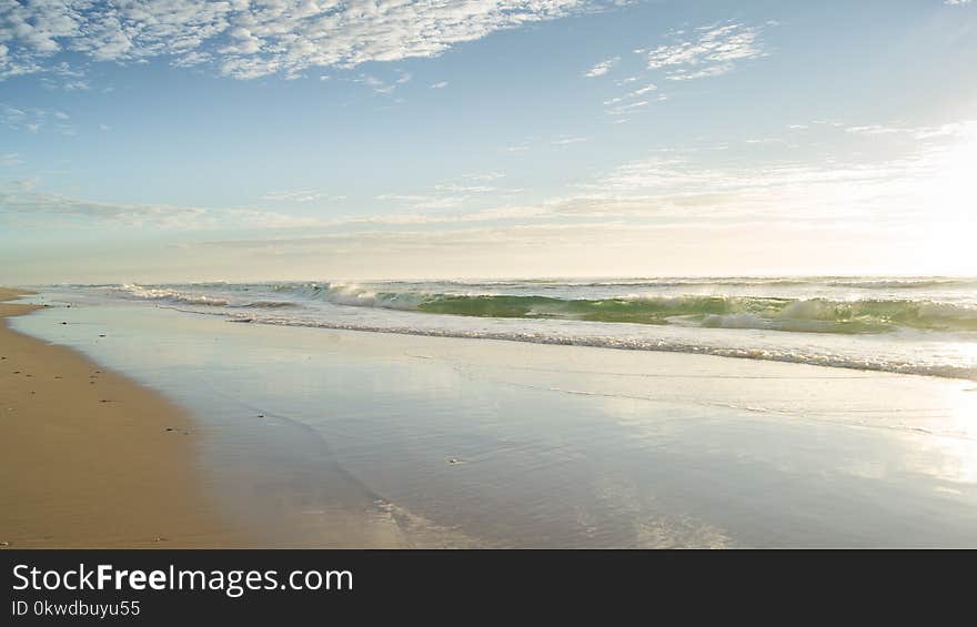 Seashore Under Clear Blue Sky