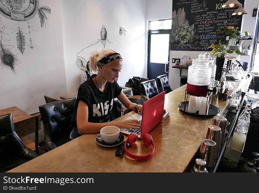 Woman Wears Black Kiss Print Crew-neck Shirts Sits