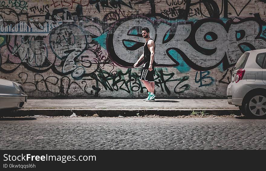 Man Standing On Sidewalk