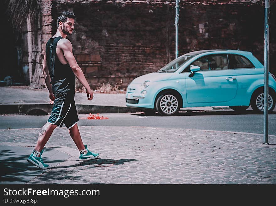 Man Wearing Black Tank Top Walking