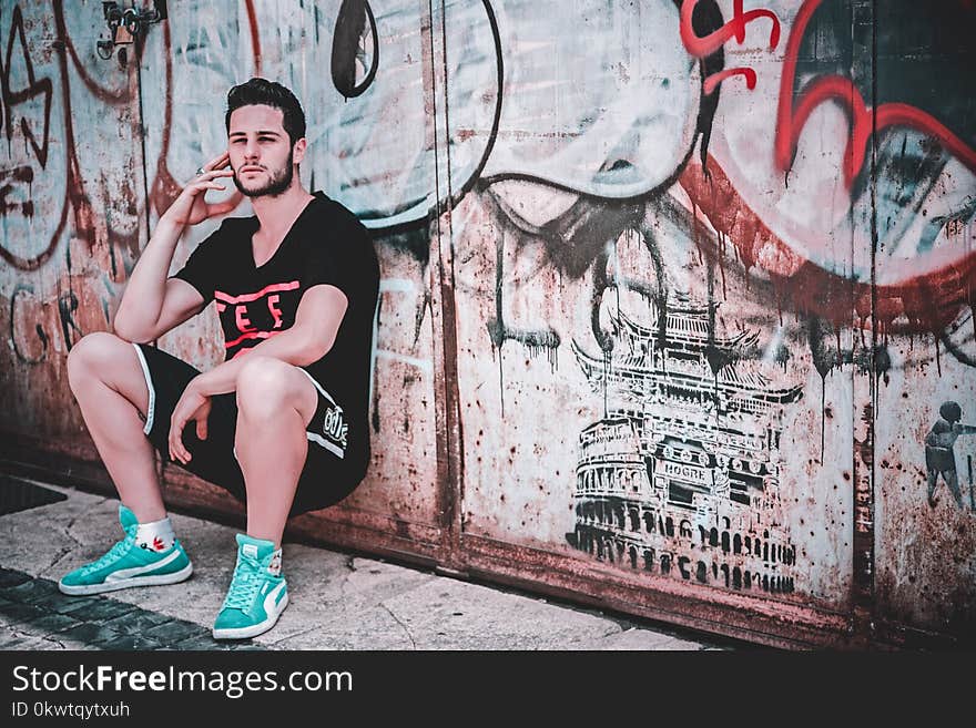 Man Leaning on Wall