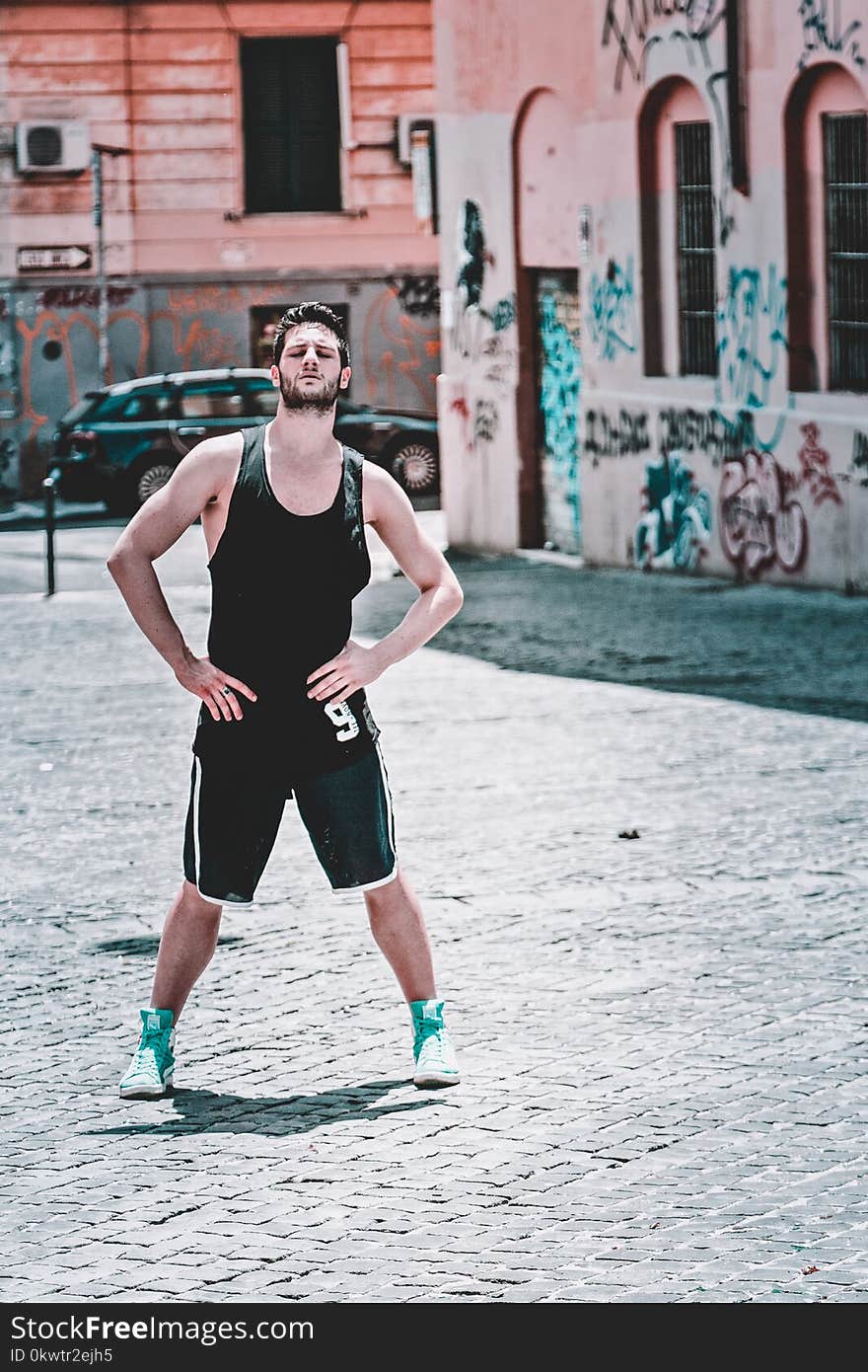 Man In Black Tank Top Posing At The Road