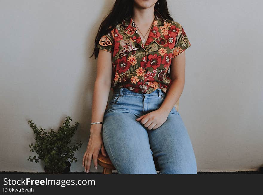 Woman Sitting on Chair Beside Green Plant