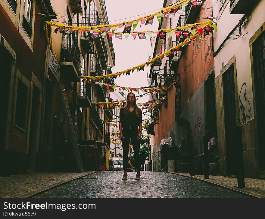 Woman Standing in Middle of Street With Bantings