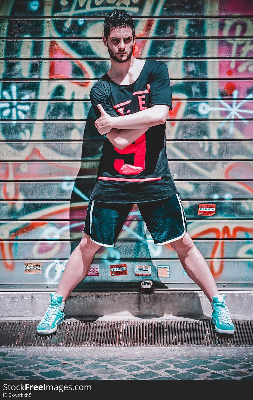 Man Wearing Black Black T-shirt and Black Gym Shorts