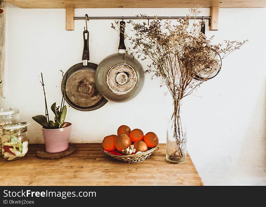 Two Gray Frying Pans Hanging on Wall