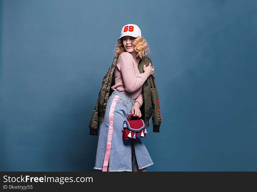 Woman in Pink Sweater and Denim Skirt