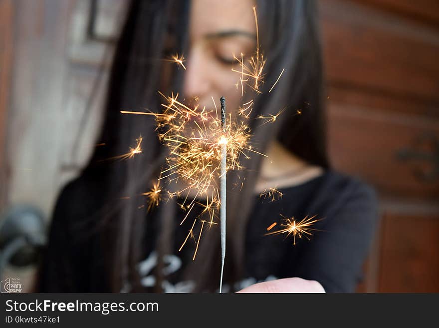 Selective Focus Photo Of Person Holding Sparkler