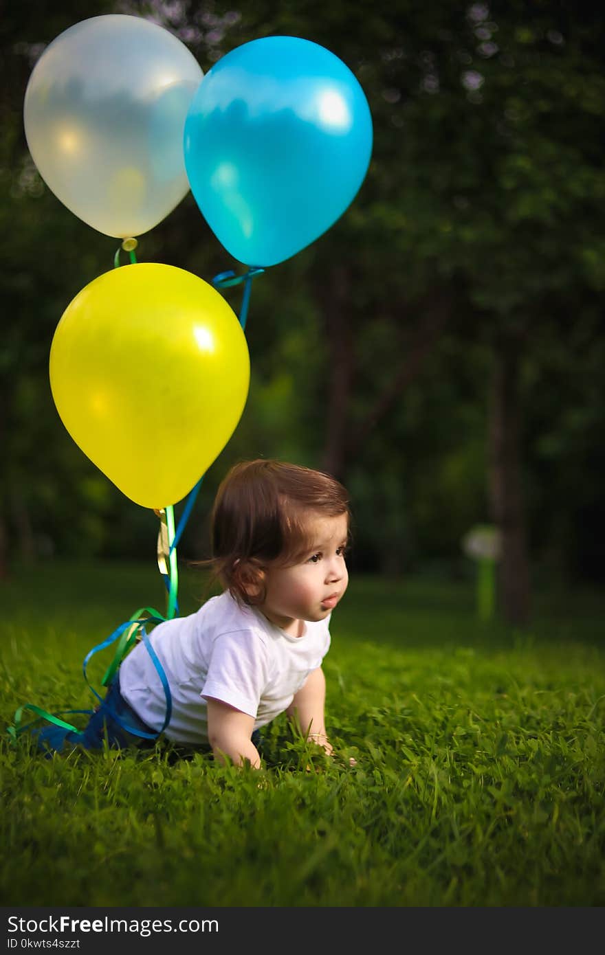 Baby Wearing White Shirt Tied With Three Balloons