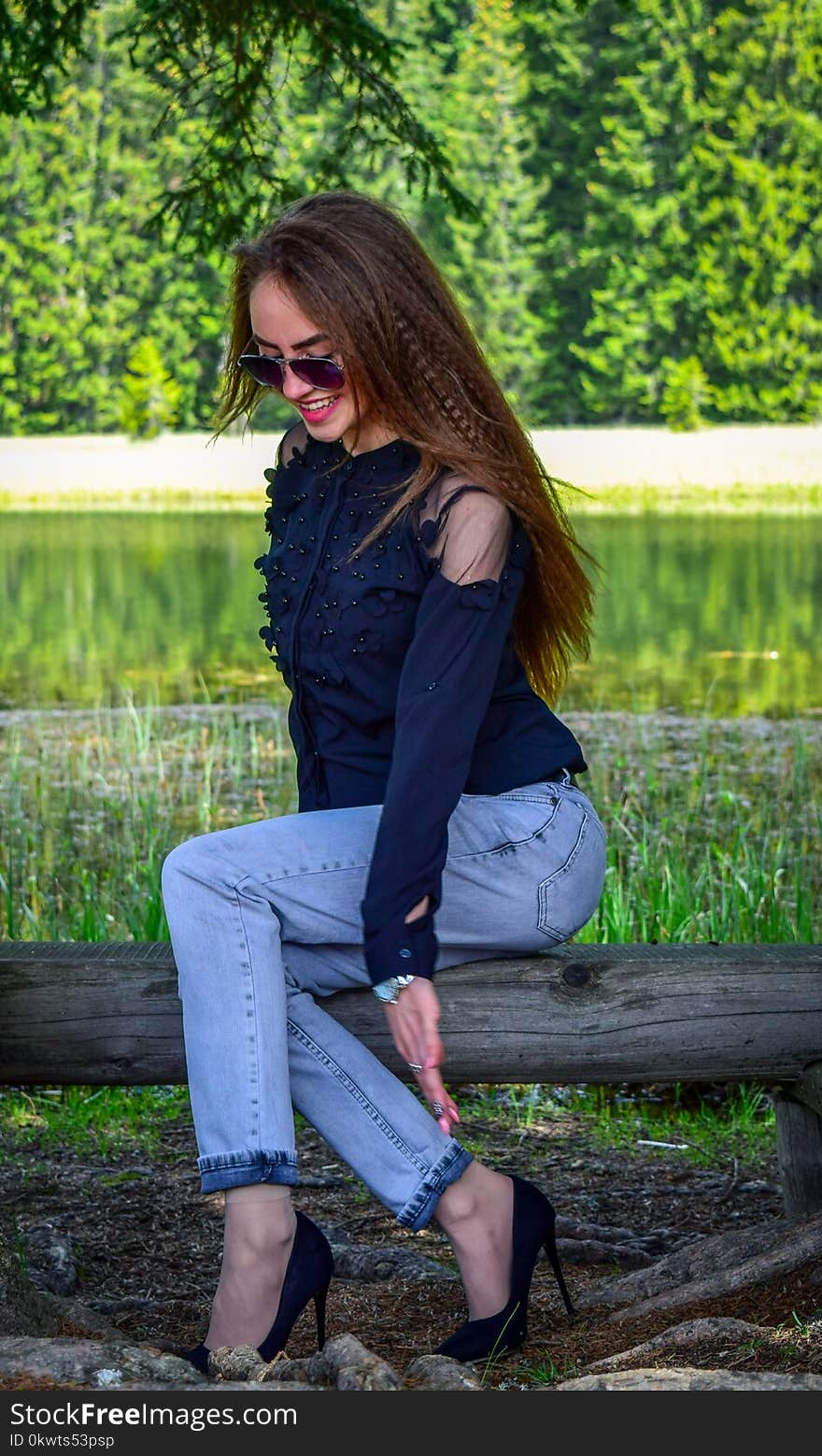 Woman Wearing Black Cold-shoulder Top and Blue Denim Jeans