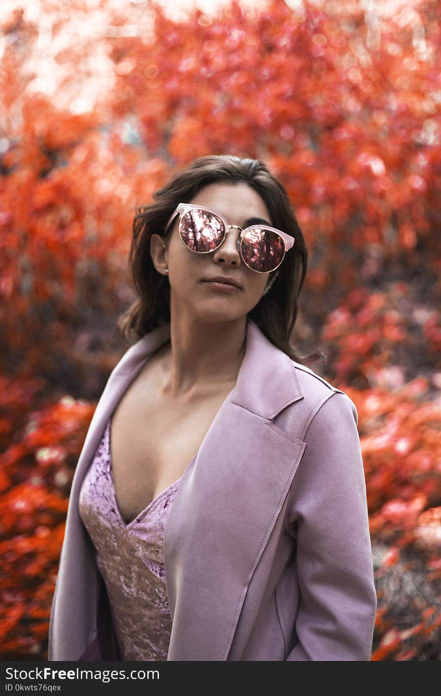 Woman Wearing Pink Blazer and Cat-eye Sunglasses