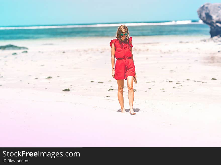 Woman Wearing Red Romper on Beach