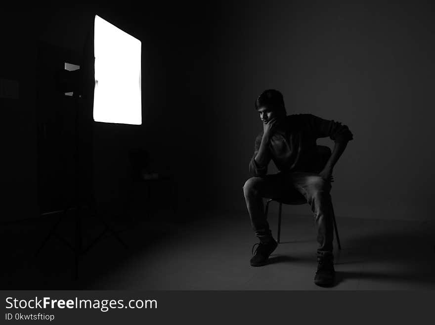 Man Sitting On Chair While Thinking