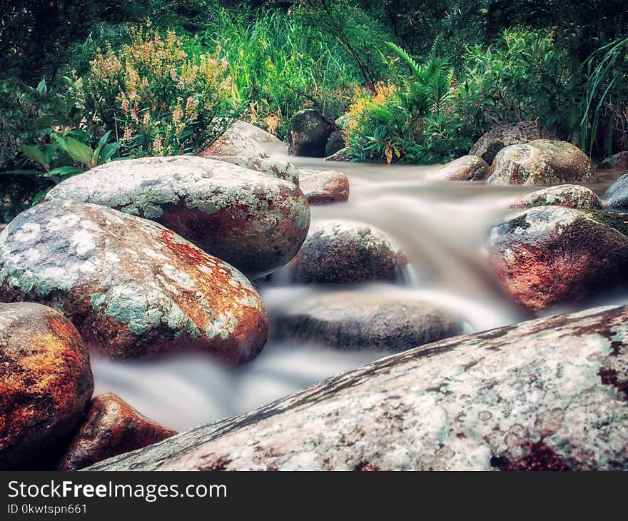 Time Lapse Photo of River Flowing on Rocks