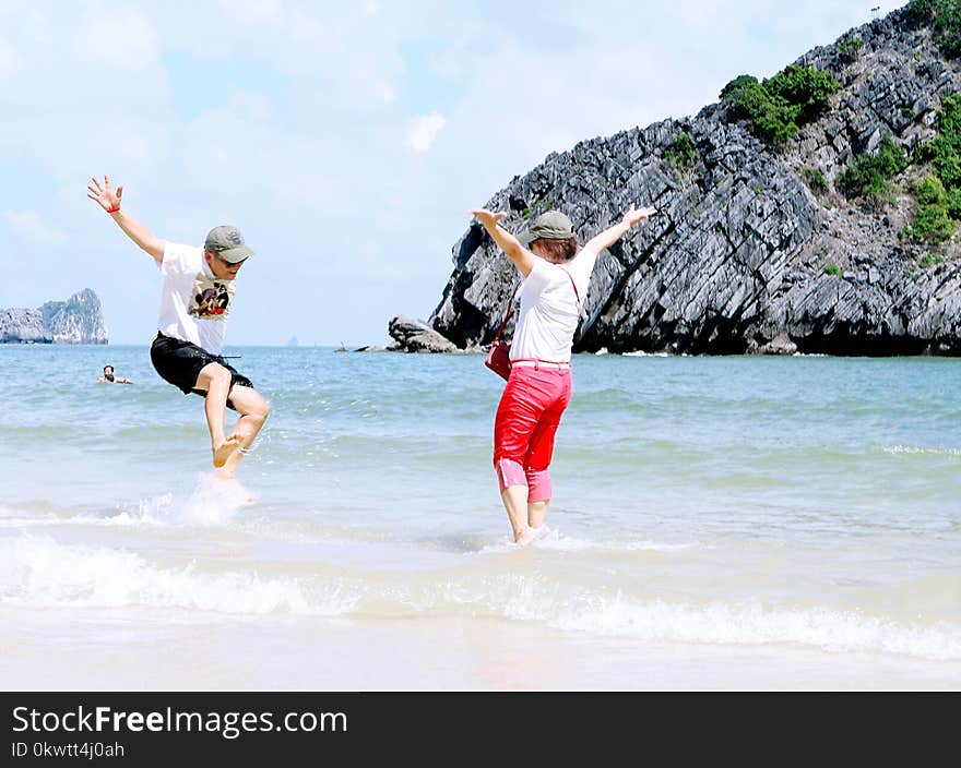 Woman And Man Playing On Seashore