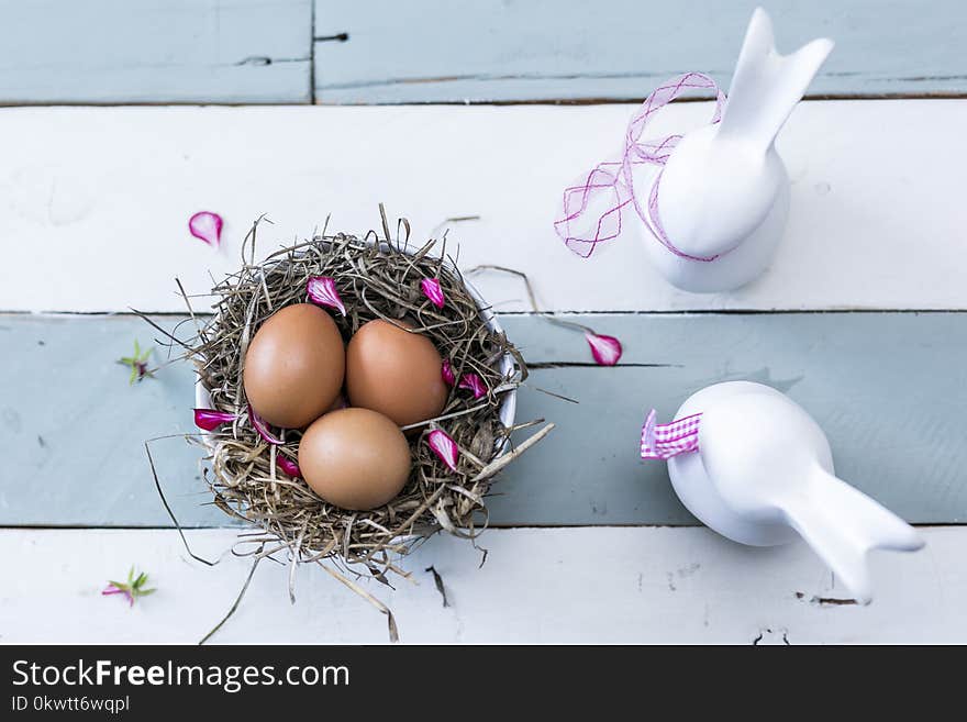 Three Brown Eggs On Nest