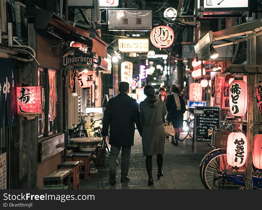 Couple Walking On Street At Night