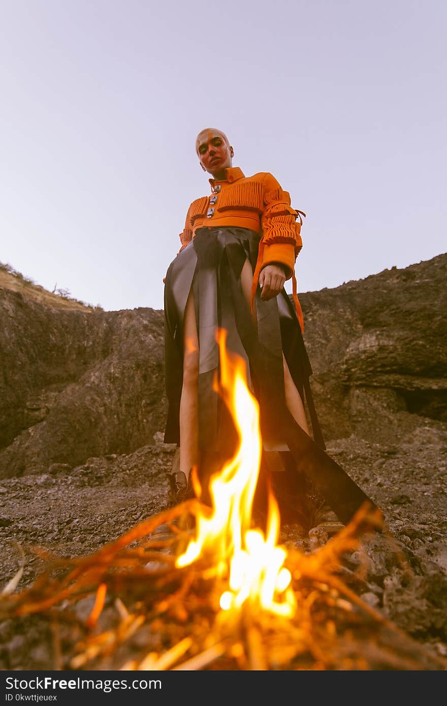 Man Wearing Orange Long-sleeved Shirt and Black Bottoms