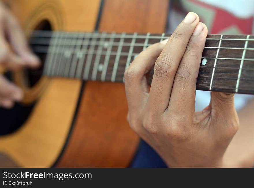 Practicing in playing bass guitar. Close up of man hand playing bass guitar. Close-up of men playing acoustic bass guitar