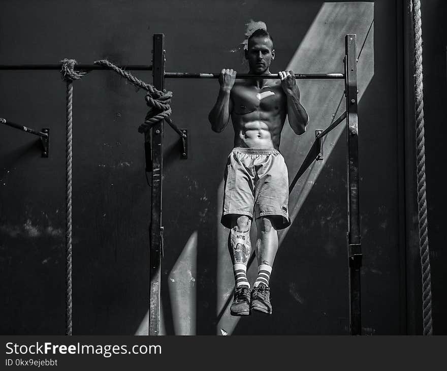 Young man hanging from gym equipment