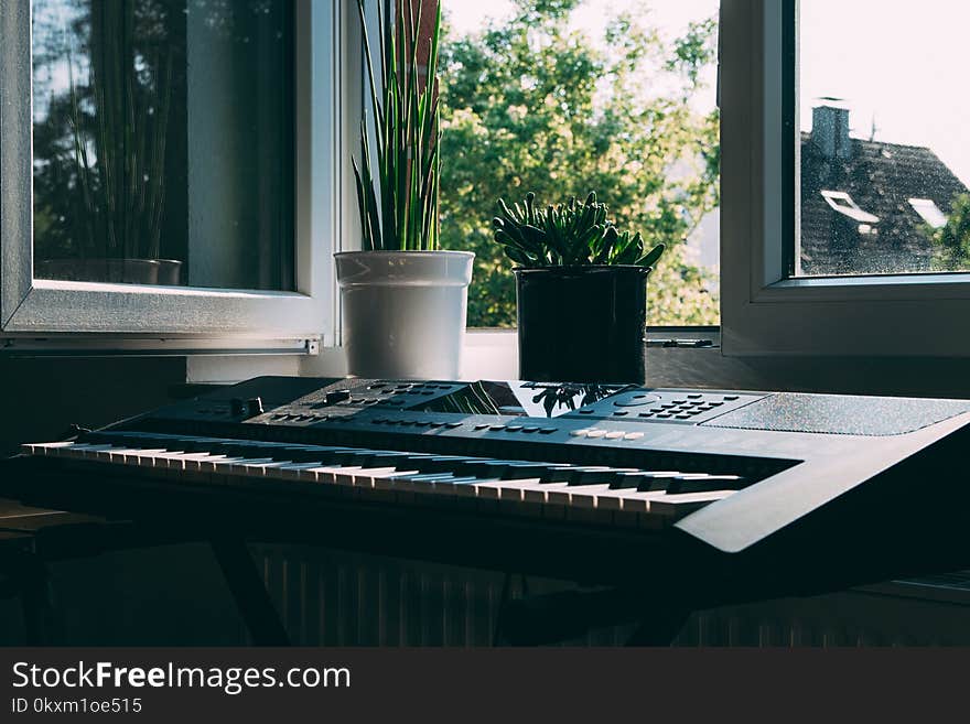 Black Electronic Keyboard Near Window